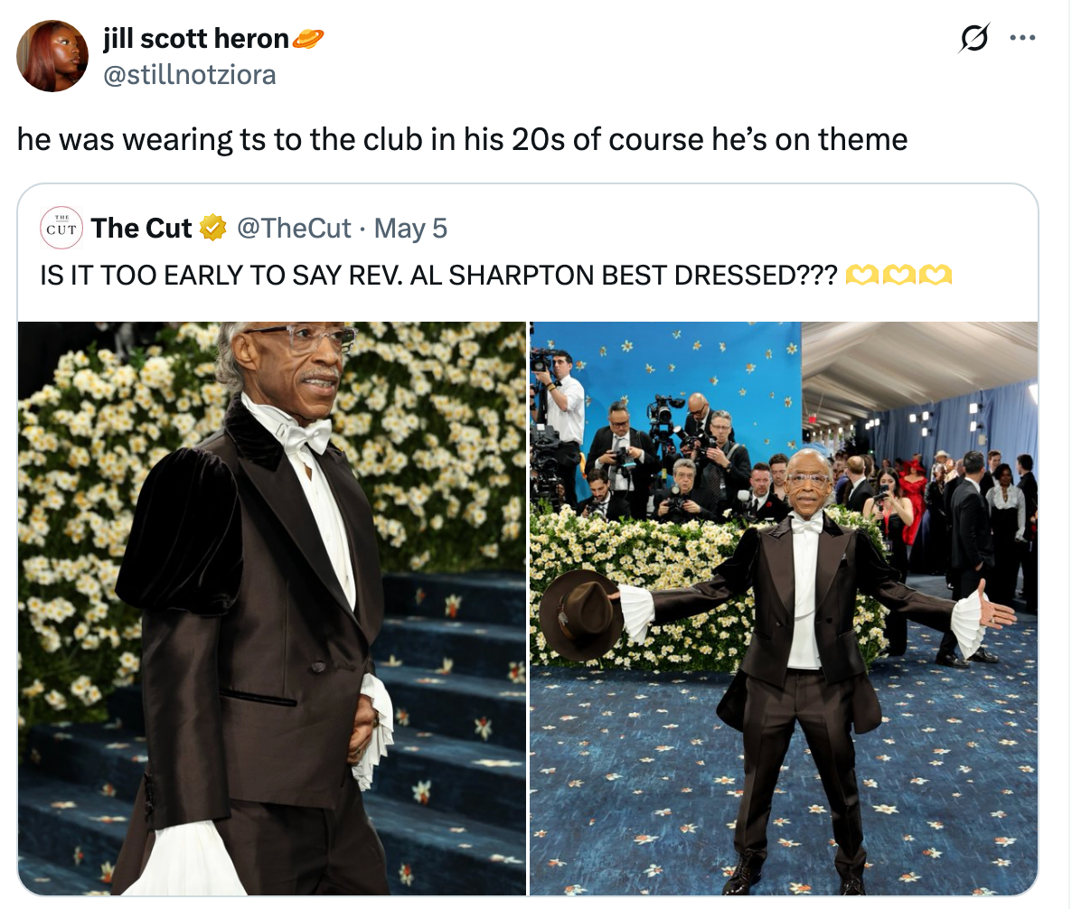 Man in a tuxedo with dramatic ruffled sleeves poses confidently on a floral-themed runway