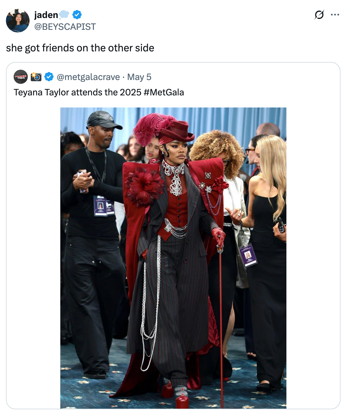 Teyana Taylor at the 2025 Met Gala wears a formal, avant-garde ensemble with layered textures, a high hat, and intricate accessories