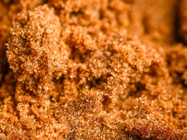 Close-up of brown sugar crystals showing coarse texture
