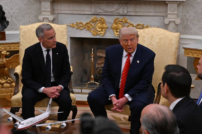 Mark Carney and Donald Trump seated and speaking with an audience in the White House