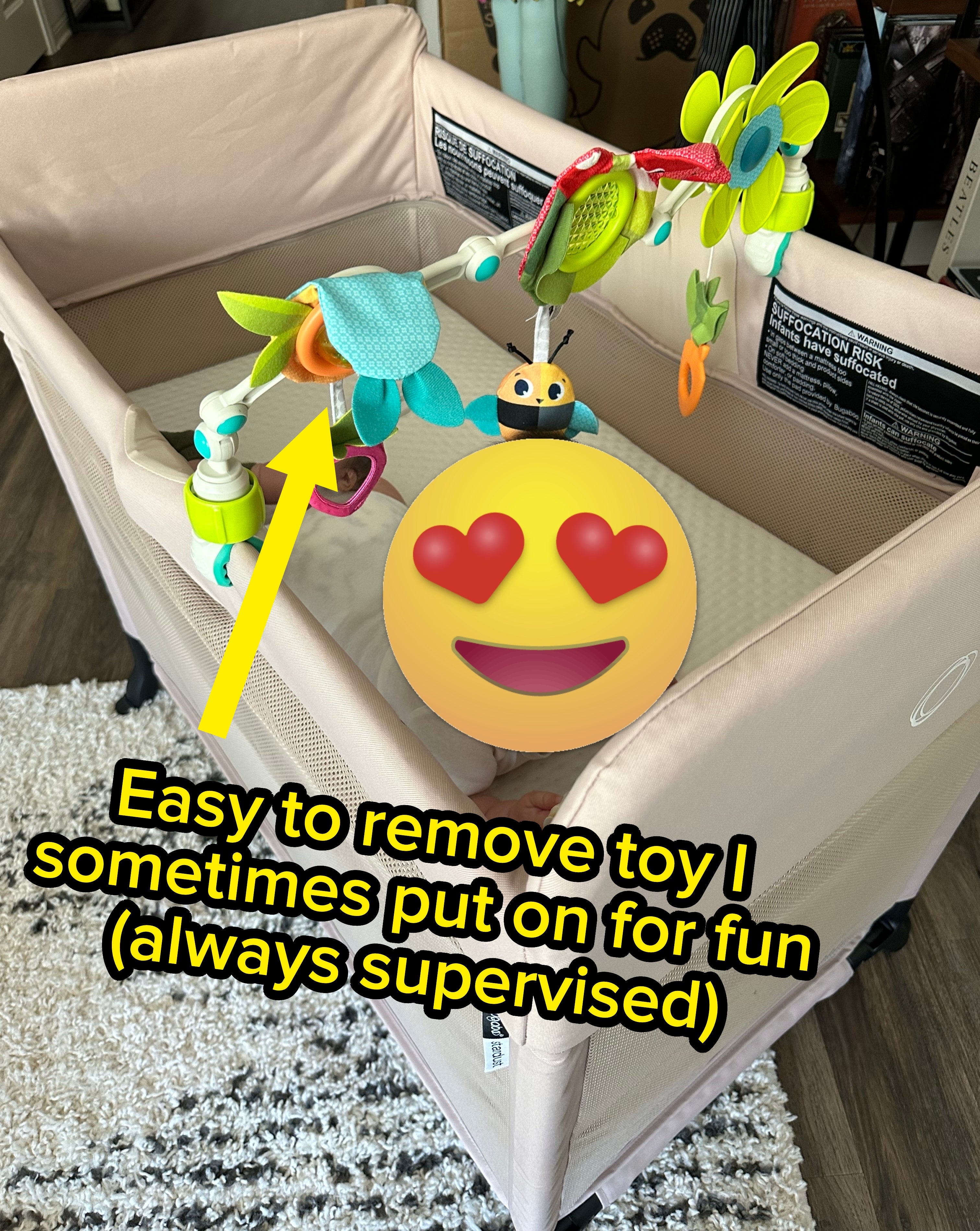 Toy attached to crib with text: "Easy to remove toy I sometimes put on for fun (always supervised)."