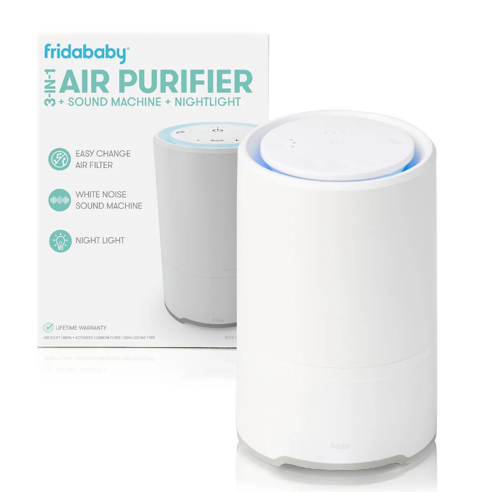 FridaBaby 3-in-1 air purifier with sound machine and nightlight, shown in front of product box highlighting easy filter change and features