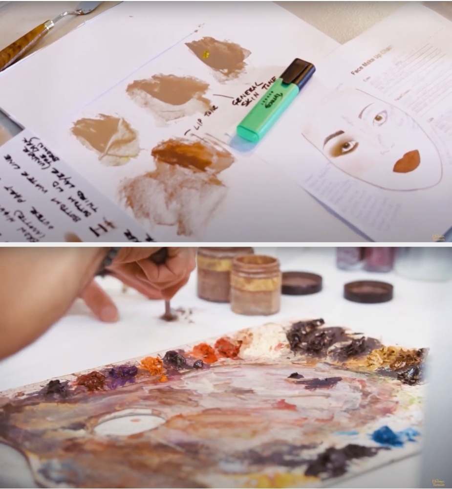Close-up of makeup and art supplies on a table, with sketches and color swatches, indicating creative preparation or planning