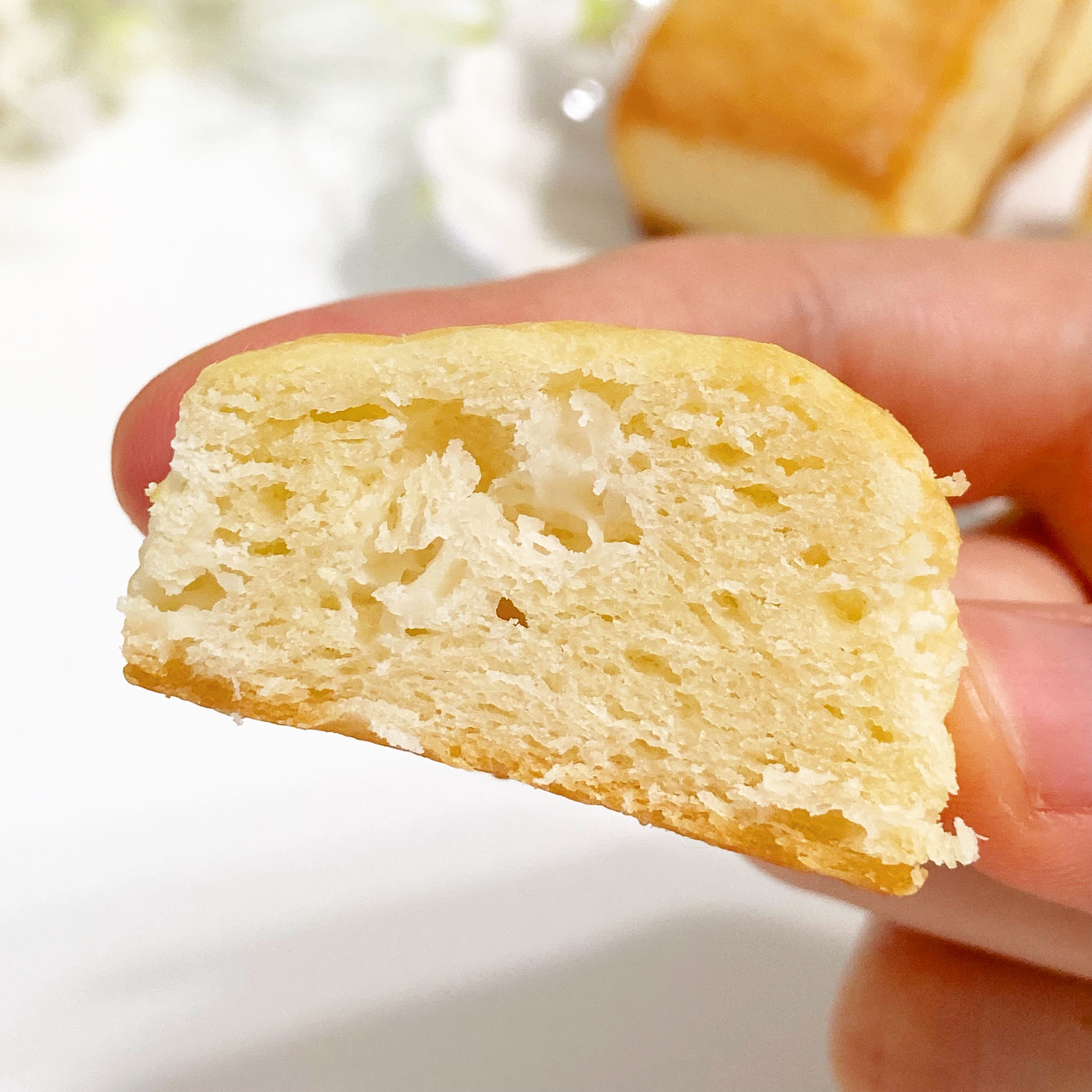 手で持たれたポンデケージョの断面が見えている。柔らかくてもちもちした質感。