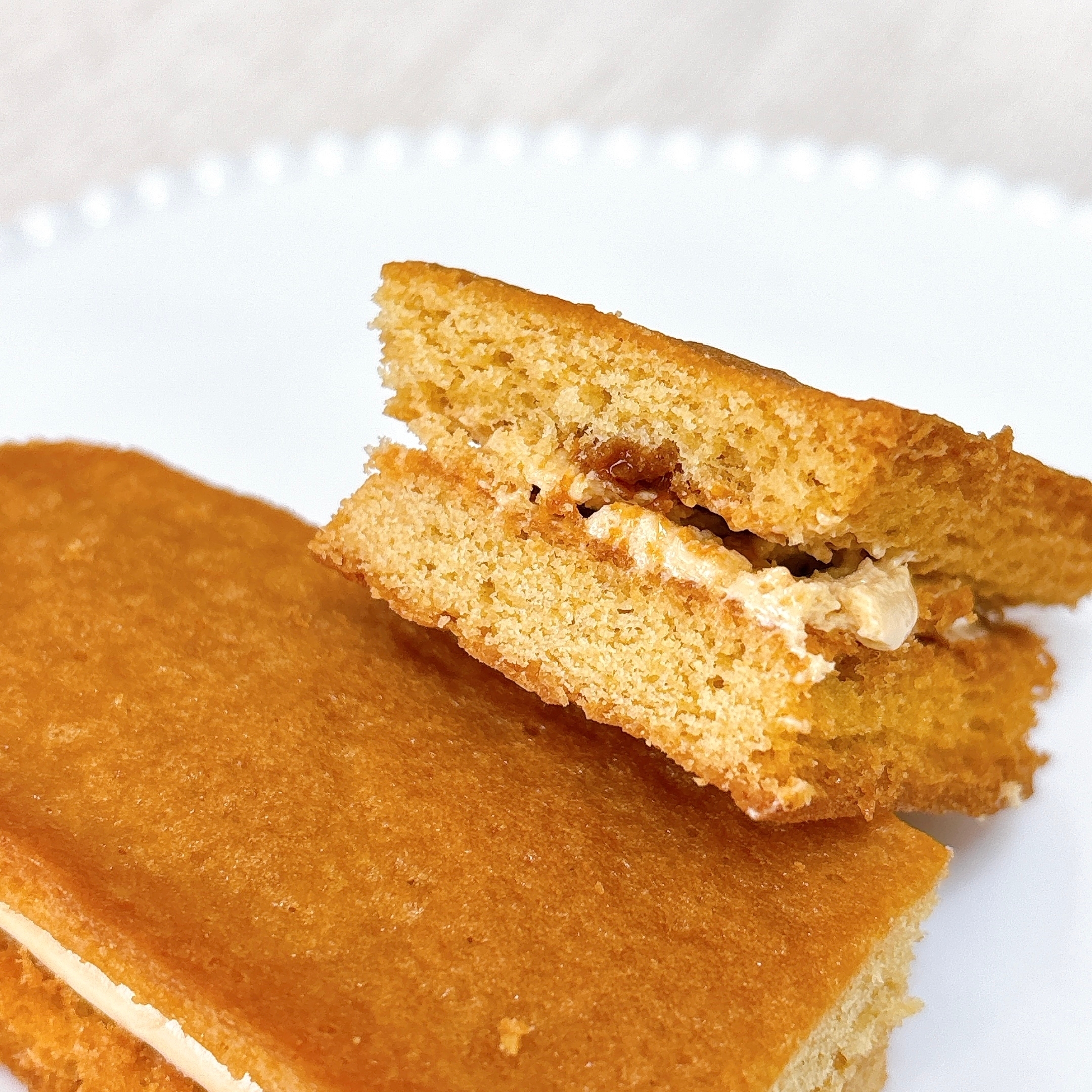 お皿にのった2切れのサンドケーキ。クリームを挟んでいます。