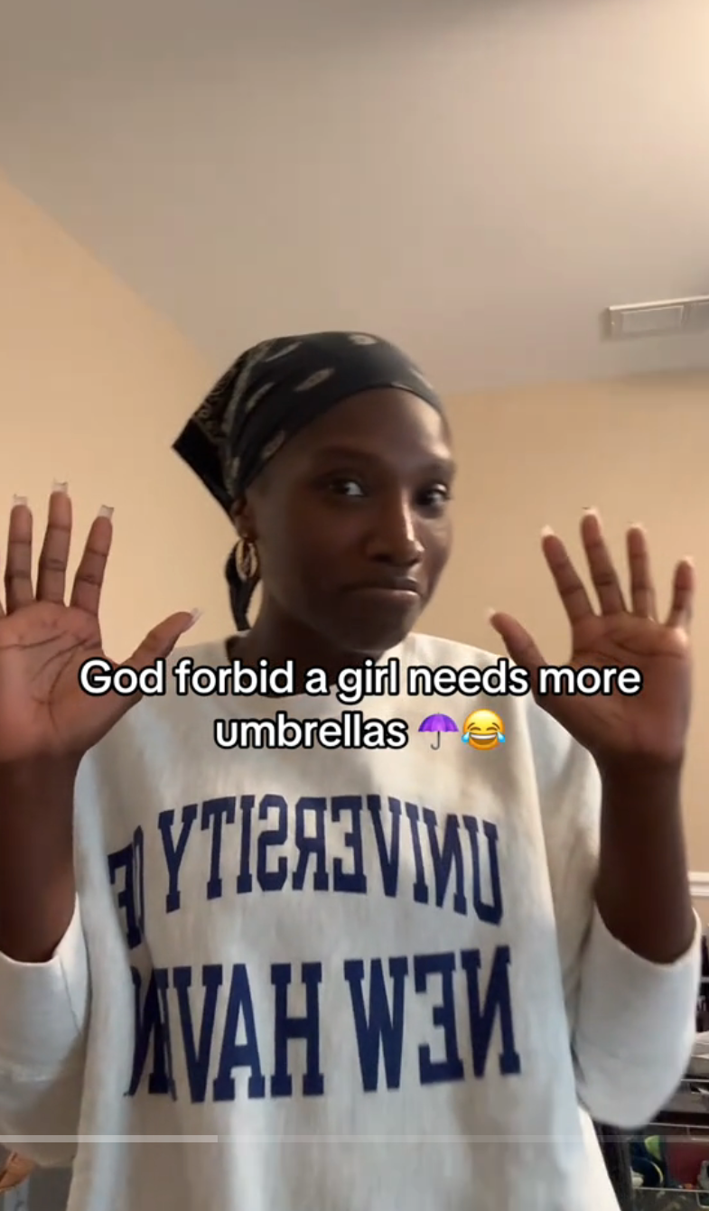 Doechii gesturing with her hands. Screen text: "God forbid a girl needs more umbrellas."