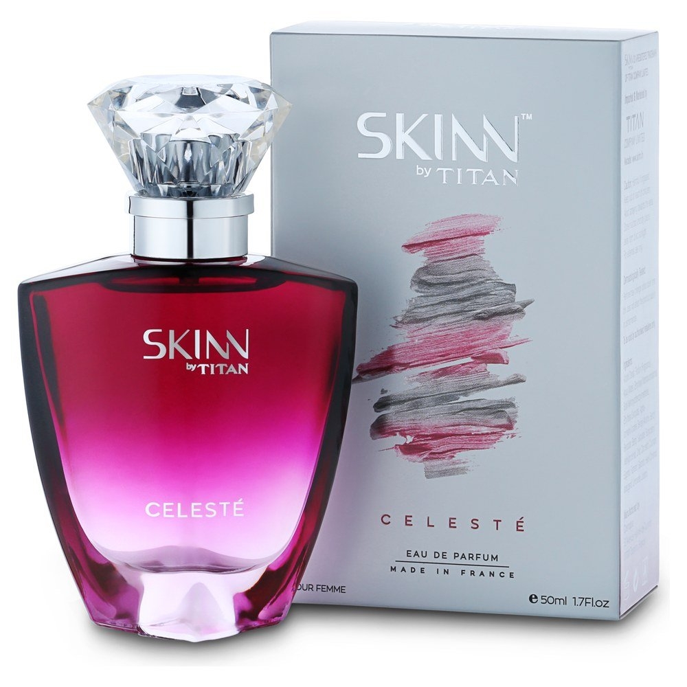 Perfume bottle labeled &quot;Skinn by Titan Celesté&quot; with a matching branded box featuring abstract brush strokes