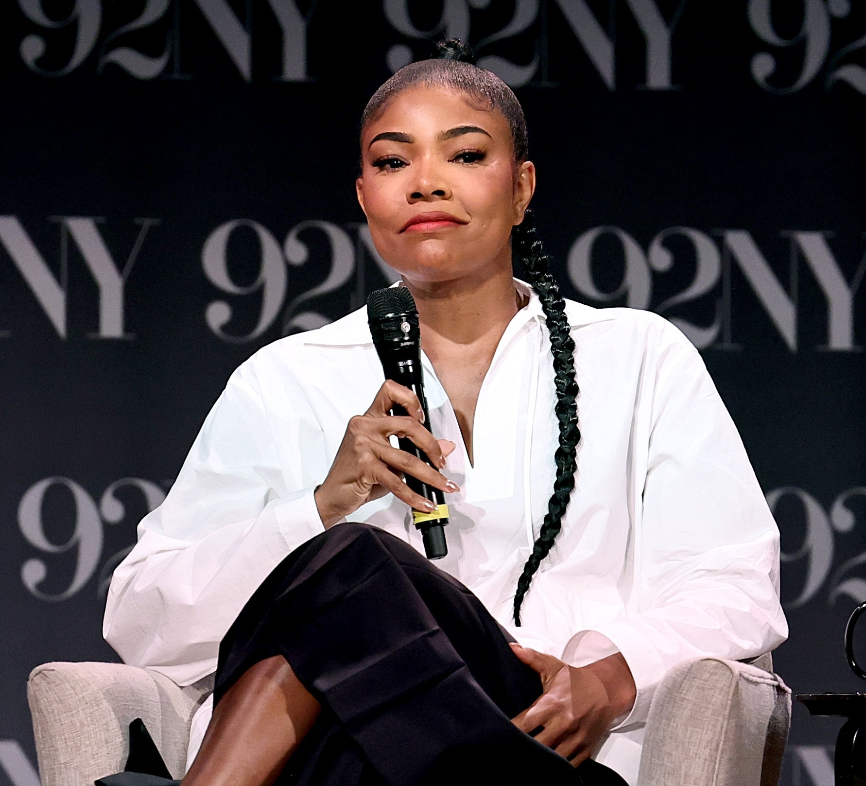 Gabrielle Union seated on stage with a microphone