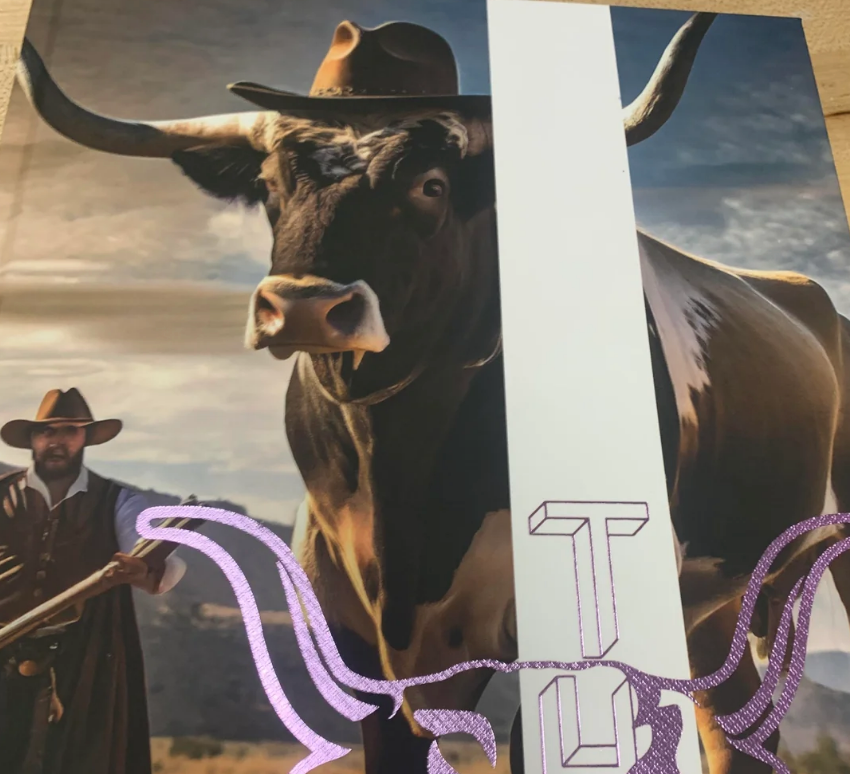 A cowboy stands beside a large, longhorn bull. The scene suggests a Western theme