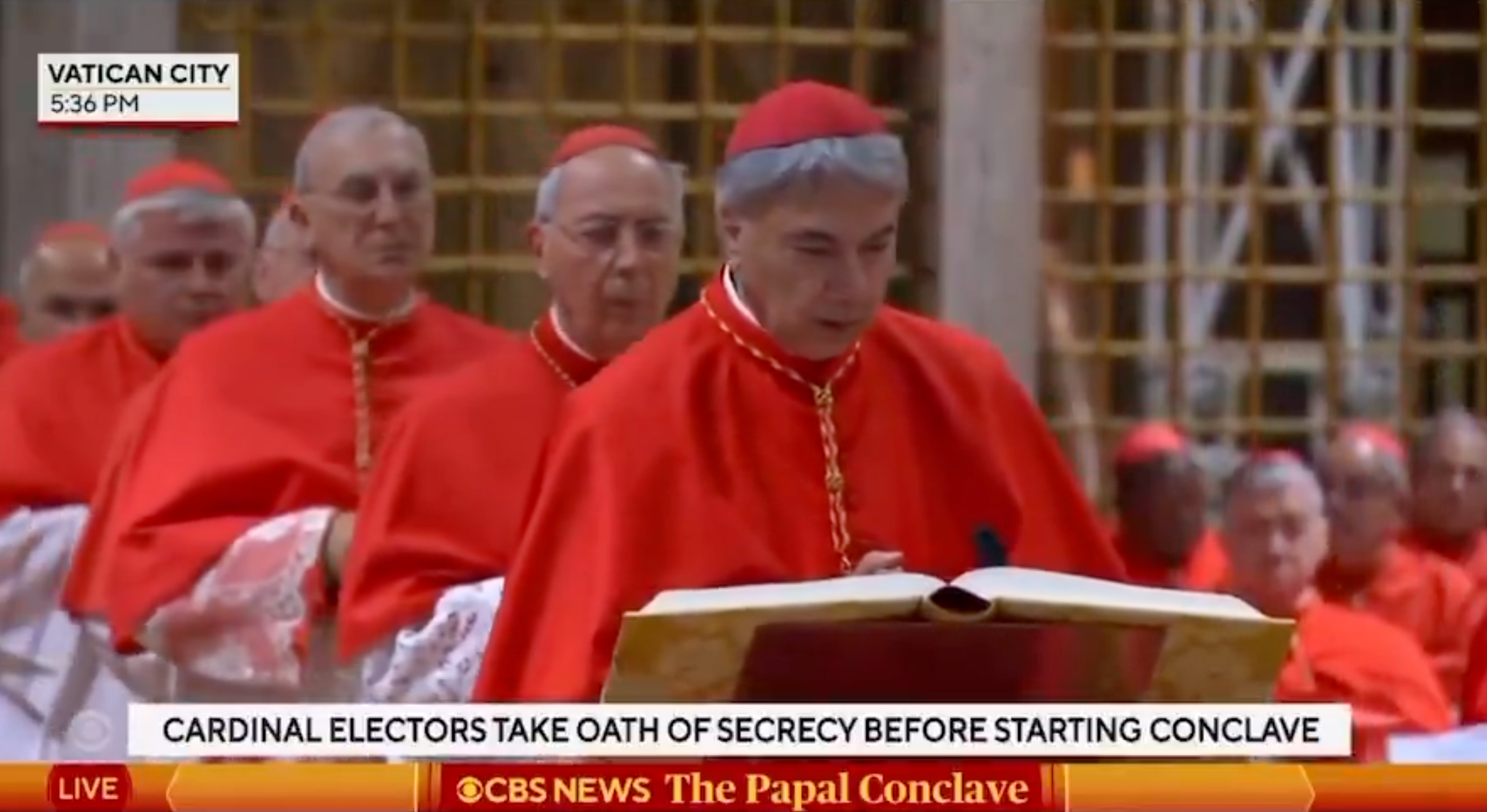 Cardinals in red robes gather for a solemn ceremony in Vatican City, taking an oath before the papal conclave
