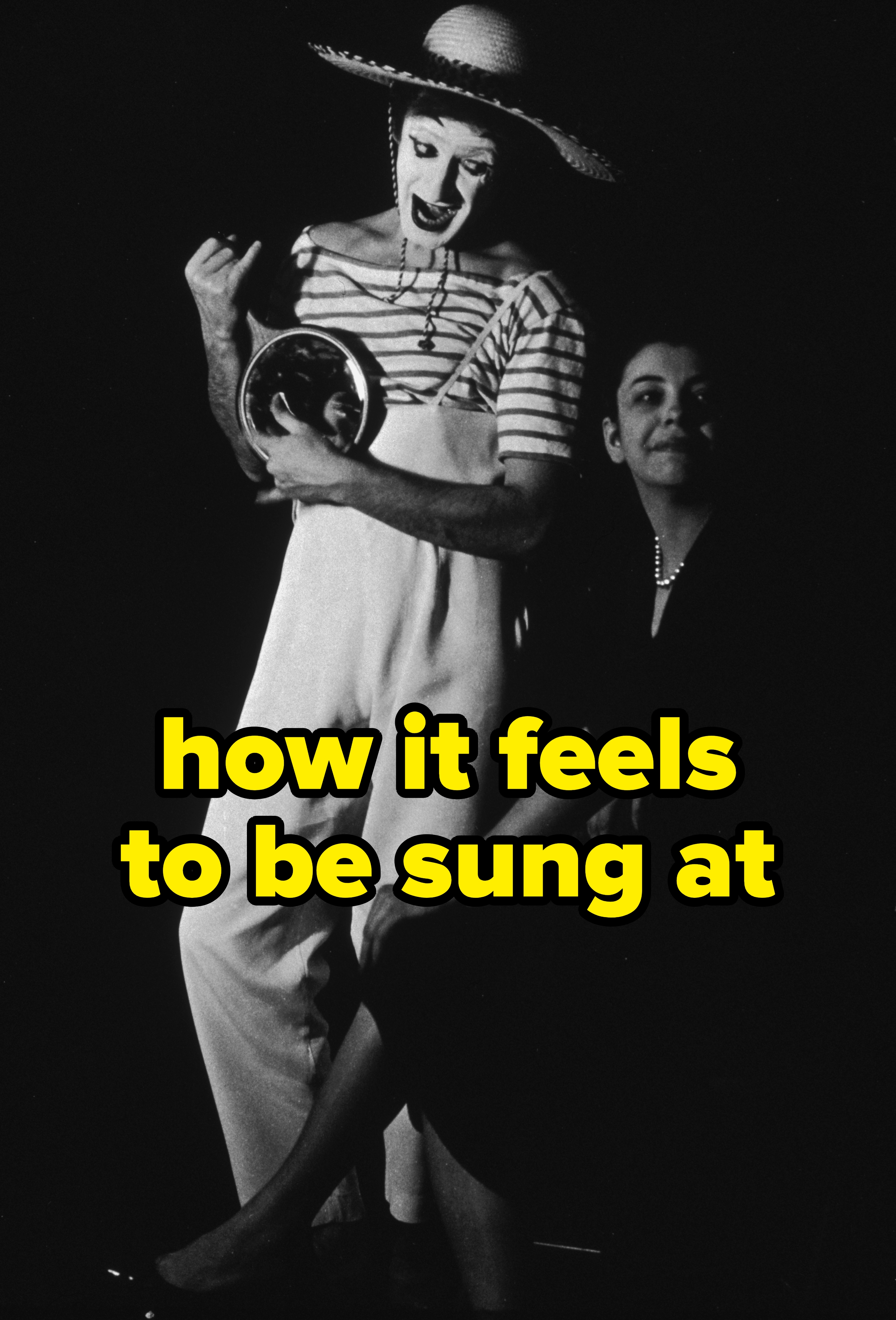 A mime in striped shirt, large hat, and overalls poses with a woman in elegant dress, both expressing theatrical gestures