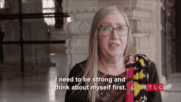 A person with long hair and glasses speaks. Subtitle reads: "I need to be strong and think about myself first."