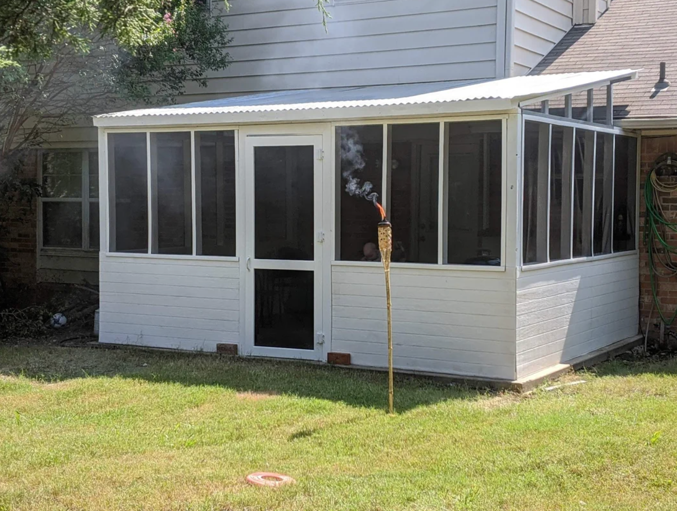 Screenshot of a Reddit post titled "Built a new screened in patio from scratch during quarantine!" showing a newly constructed screened patio attached to a house