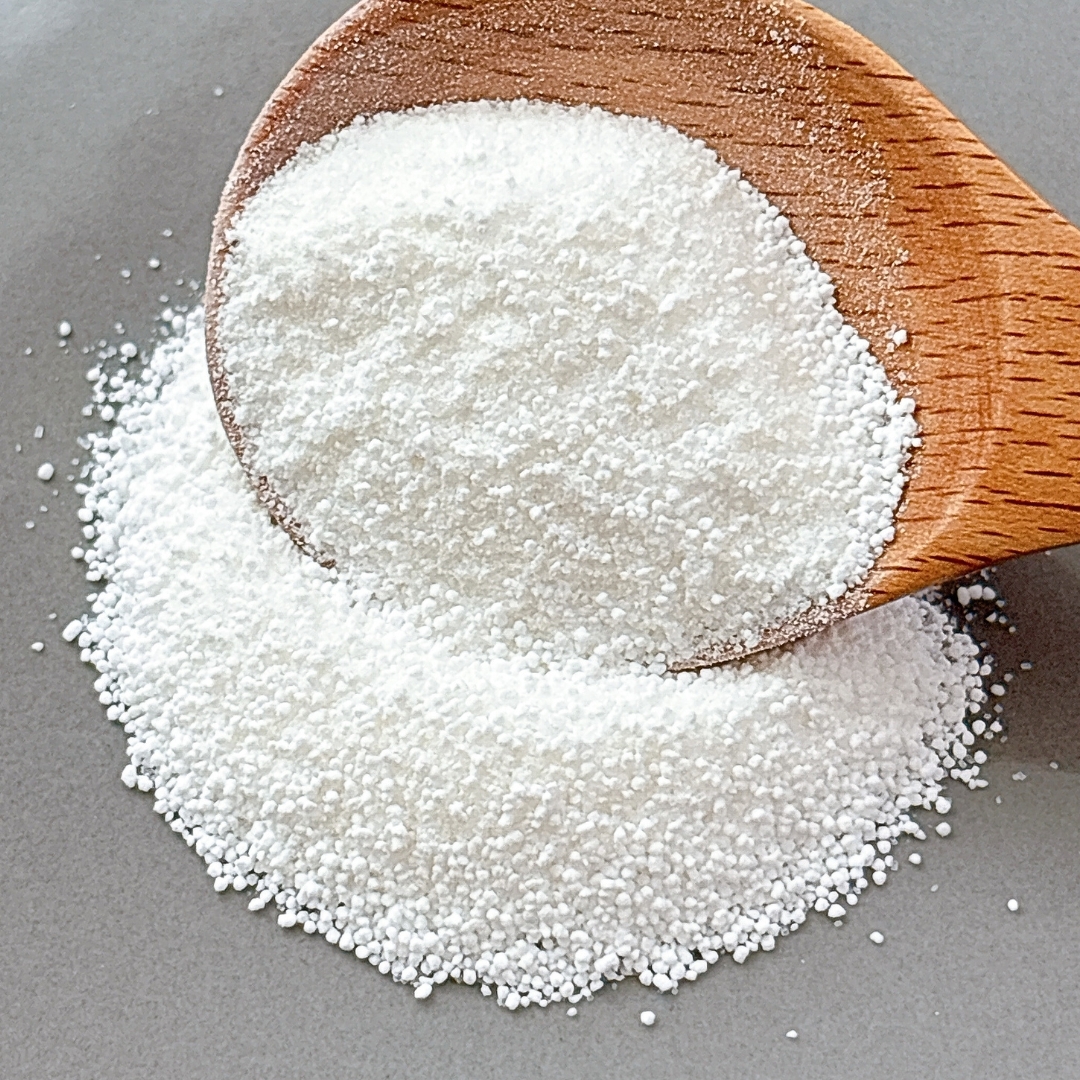 木のスプーンに山盛りの白い細かい粒状の粉がのせられている。