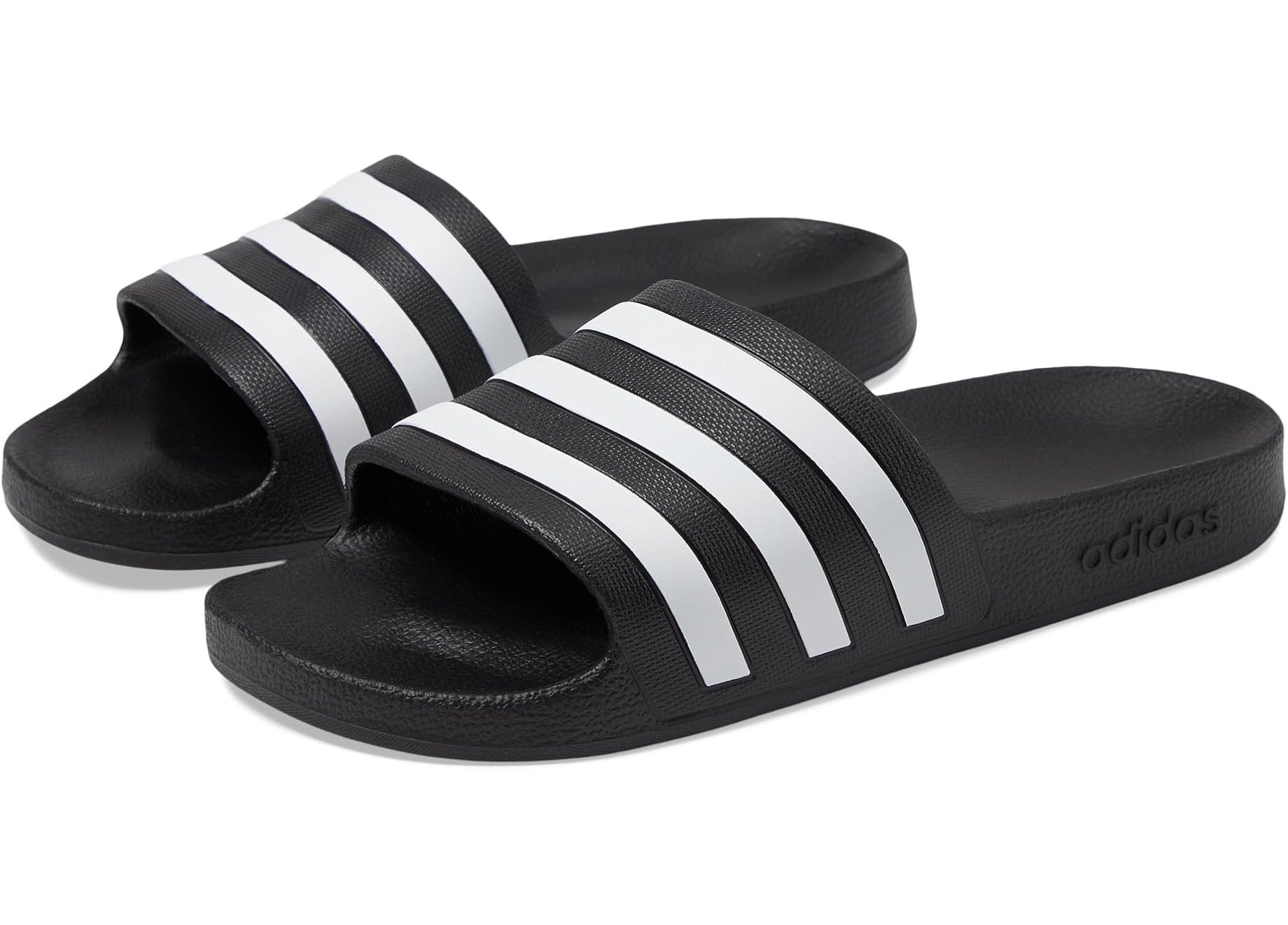 Adidas slide sandals with a cushioned sole and bold horizontal stripes across the top band
