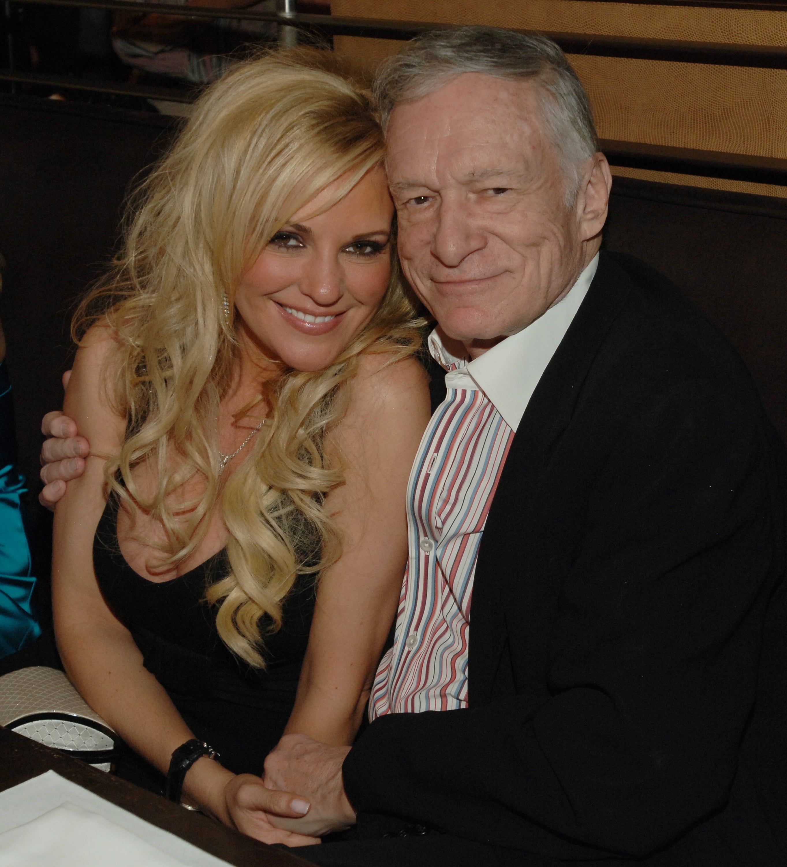 Bridget Marquardt and Hugh Hefner seated closely, smiling