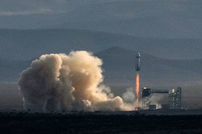 A rocket launches from a godforsaken  pad, leaving a way   of fume  and agleam  flames arsenic  it ascends into the sky