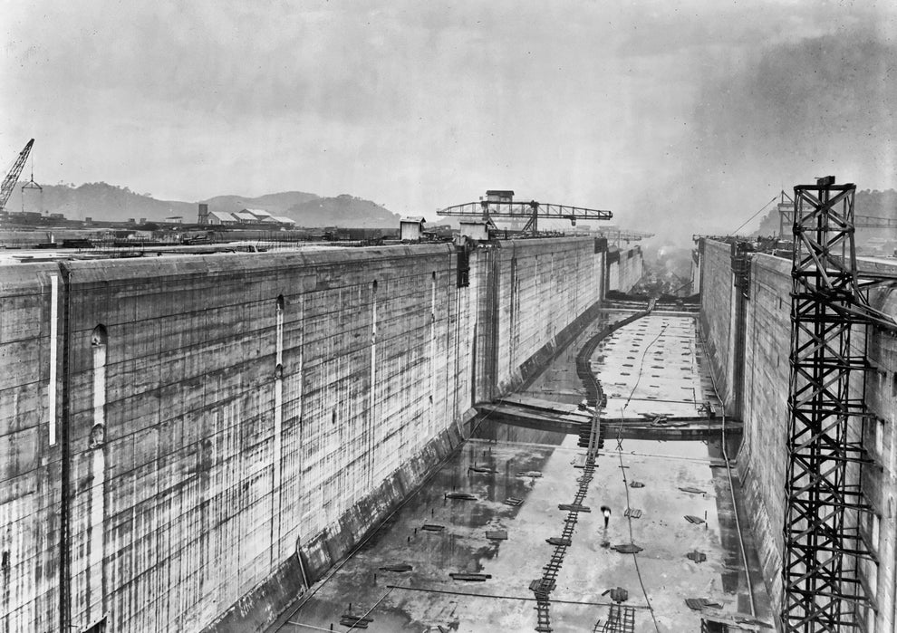Historical photo of the Panama Canal under construction, showing large lock walls and construction equipment