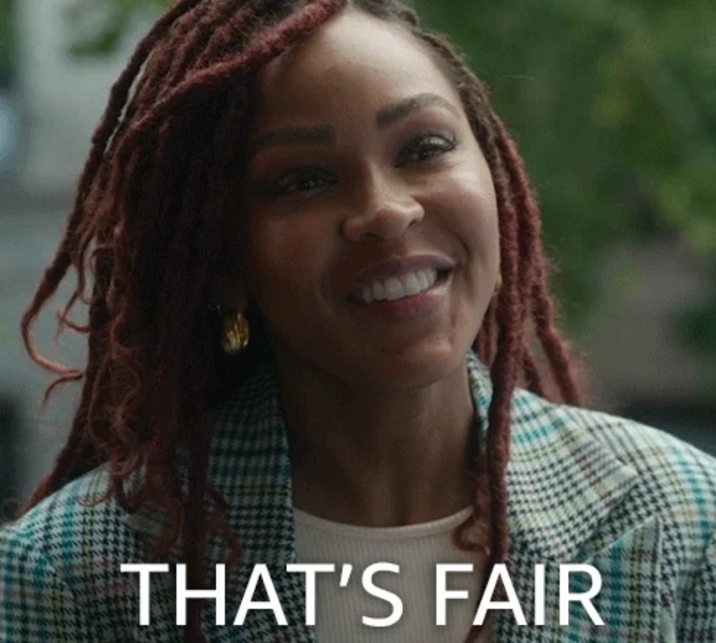 Smiling person with braided hair, wearing a plaid coat, with the text "That's Fair" below