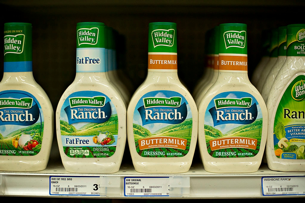 Bottles of Hidden Valley Ranch dressing, including fat-free and buttermilk varieties, displayed on a store shelf