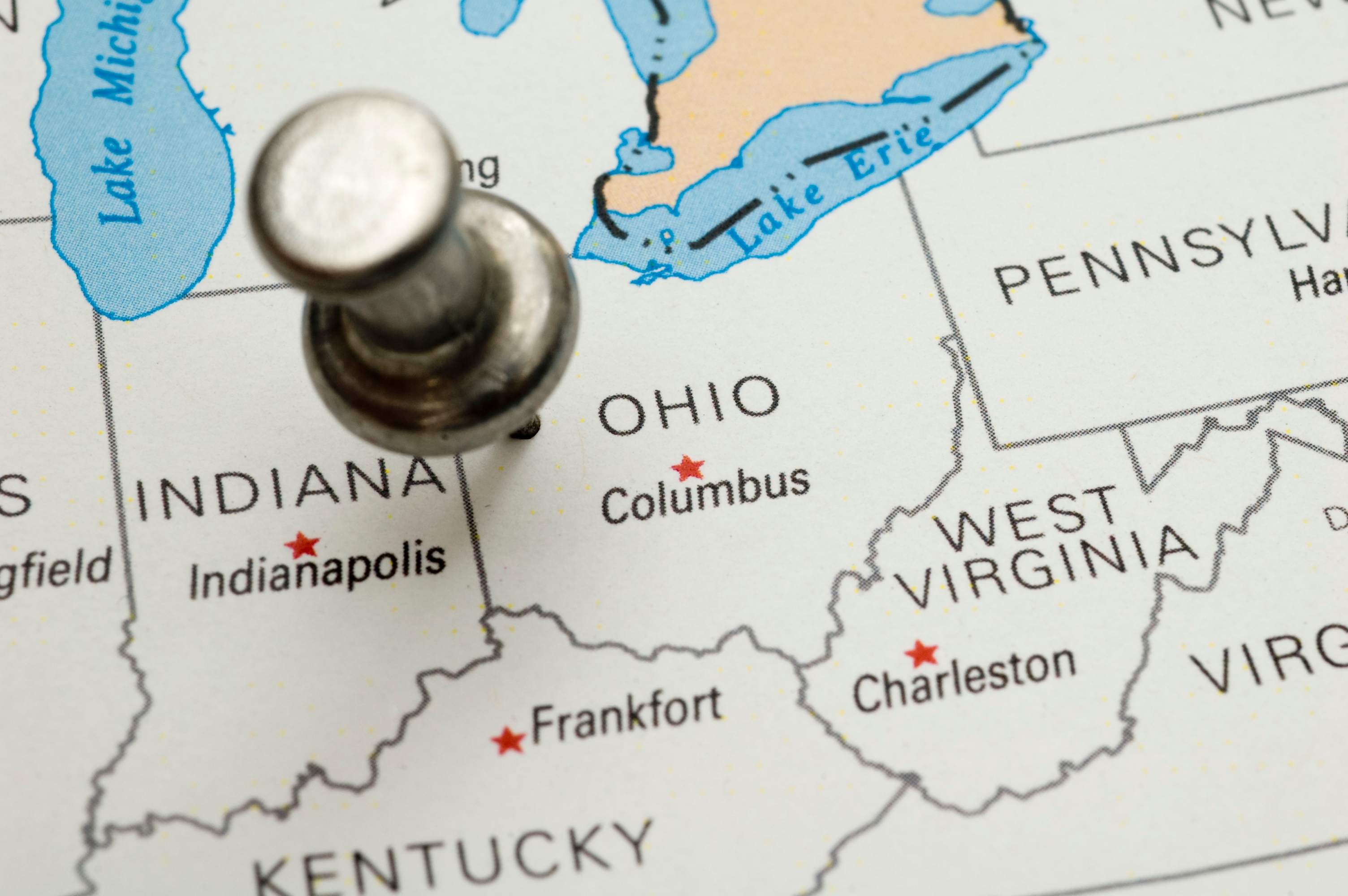 Close-up of a U.S. map with a pushpin marking Columbus, Ohio, highlighting major cities like Indianapolis and Charleston