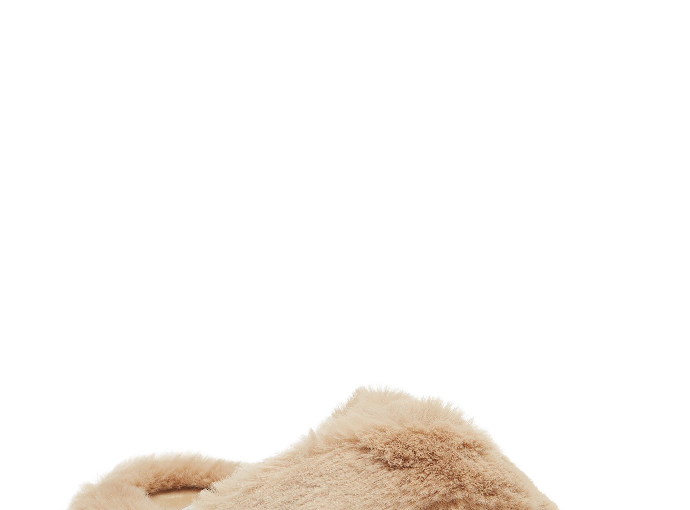 Fuzzy slipper with crisscross straps, ideal for cozy, indoor wear. Featured in a shopping article