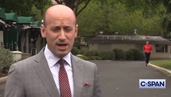 A man in a suit speaks outdoors; a person walks in the background. C-SPAN logo in the corner