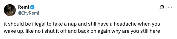 Tweet from a user expressing frustration about waking up from a nap with a persistent headache