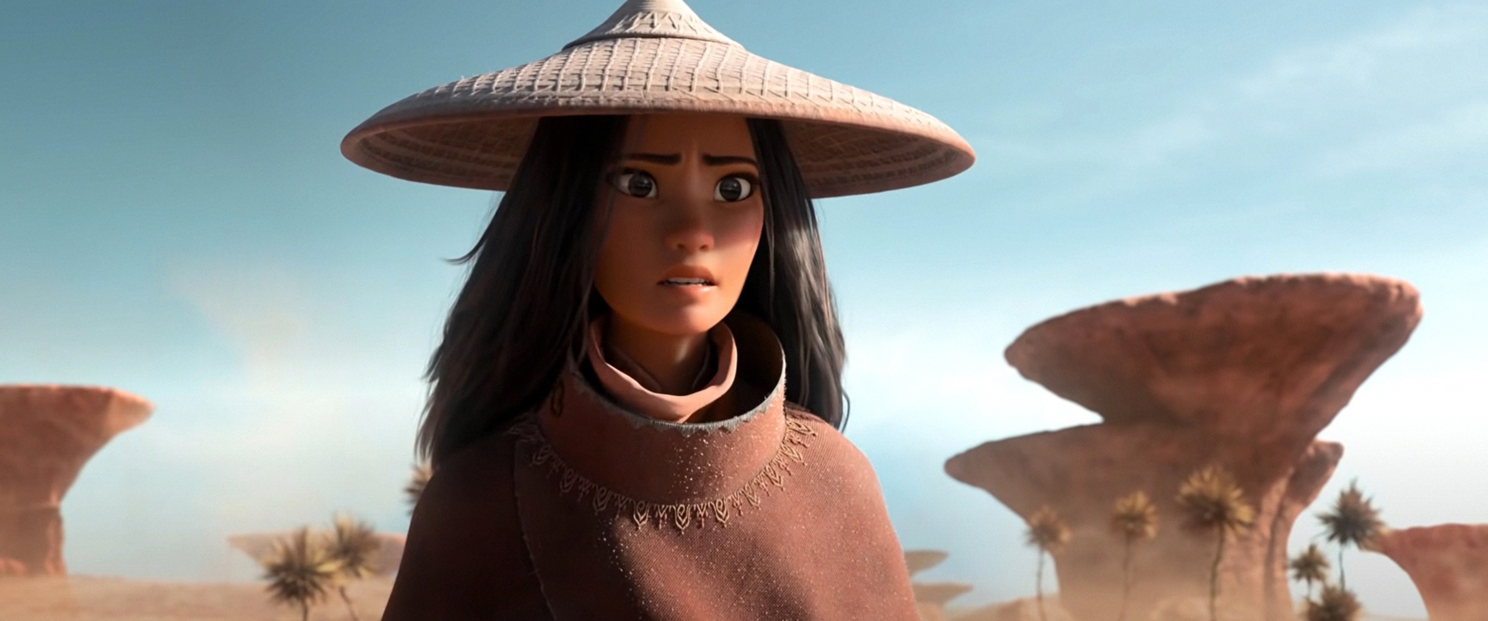 Animated character with a wide-brimmed hat stands in a desert landscape with rock formations in the background