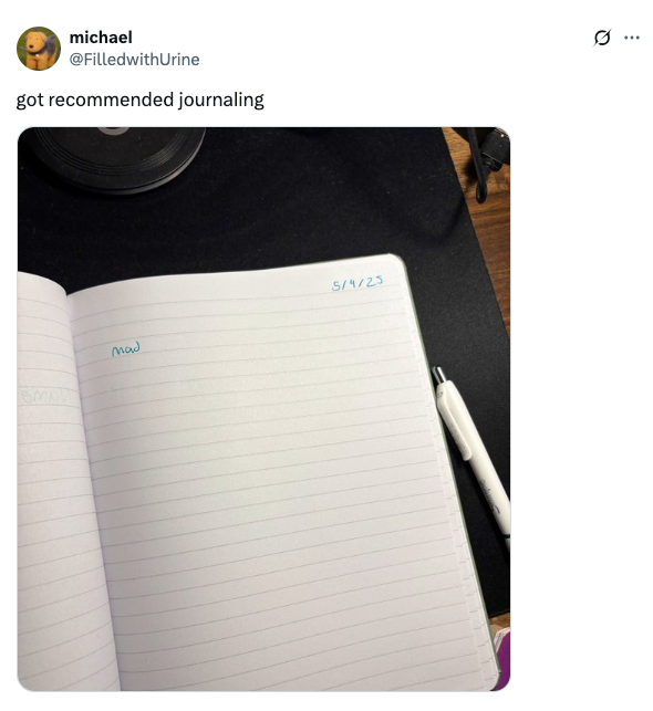 Open notebook page dated 5/4/23 with the word "Mad" written; pen nearby