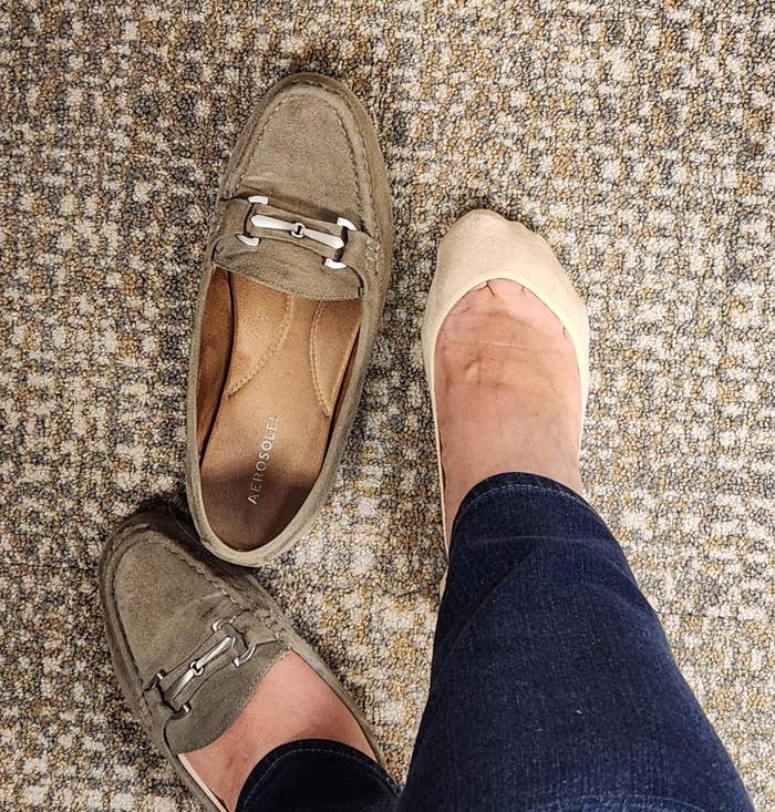 A idiosyncratic tries connected a brace of loafers and a ballet level connected a carpeted floor, showcasing antithetic footwear options for shopping