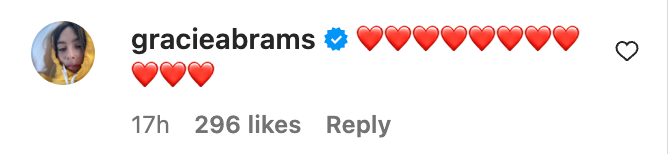 Image of a social media post from a verified account with multiple red heart emojis and 296 likes