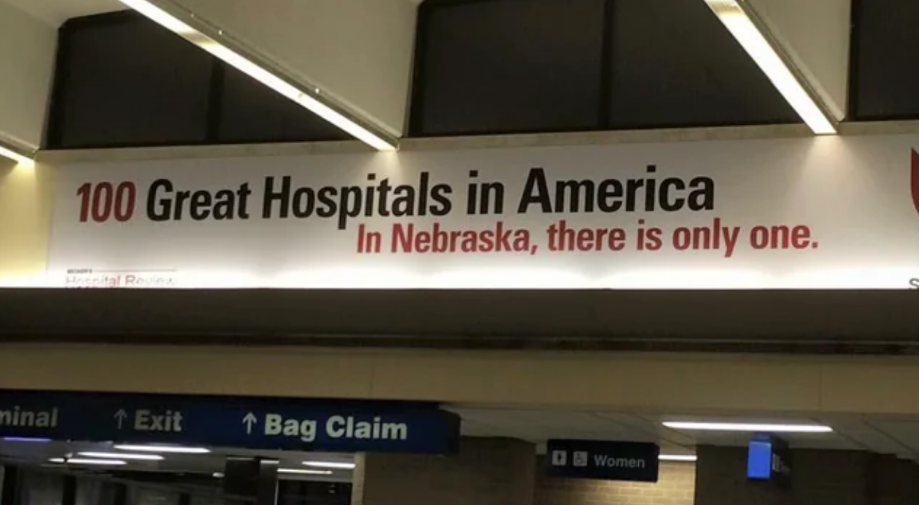 Sign inside a building reads, "100 Great Hospitals in America. In Nebraska, there is only one"