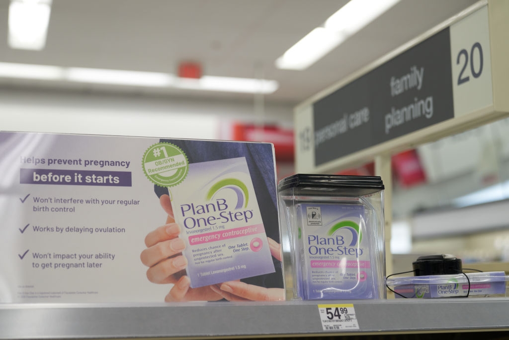 Plan B One-Step display on a pharmacy shelf highlighting benefits like effective prevention before pregnancy starts and no impact on future fertility