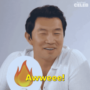 Person holding a &quot;fire&quot; emoji sign with &quot;Awwwee!&quot; text, appearing delighted