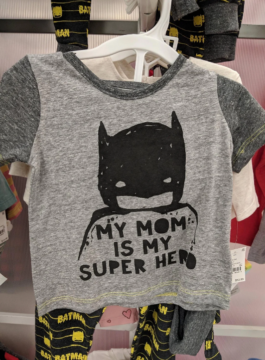 Children's T-shirt on hanger with a Batman mask and the text "My Mom is My Super Hero" printed on the front