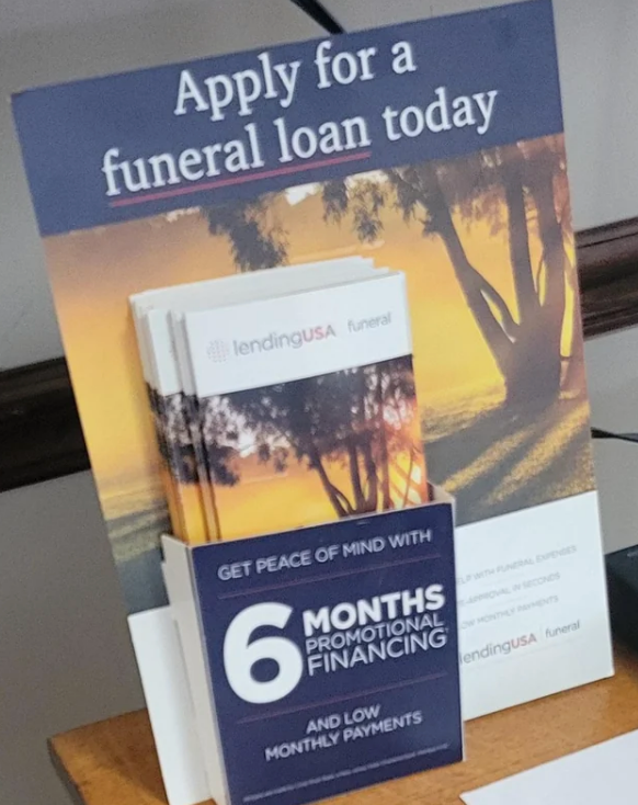 Brochure stand for funeral loans by LendingUSA offers six months of promotional financing and low monthly payments