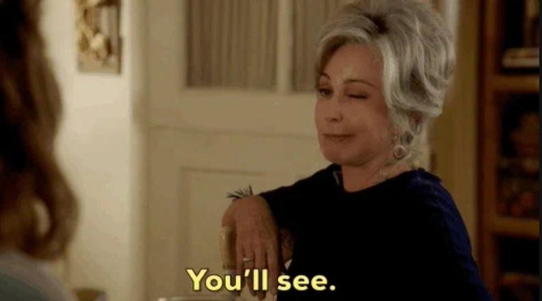 Older woman winks while leaning on a chair, with text saying, "You'll see."