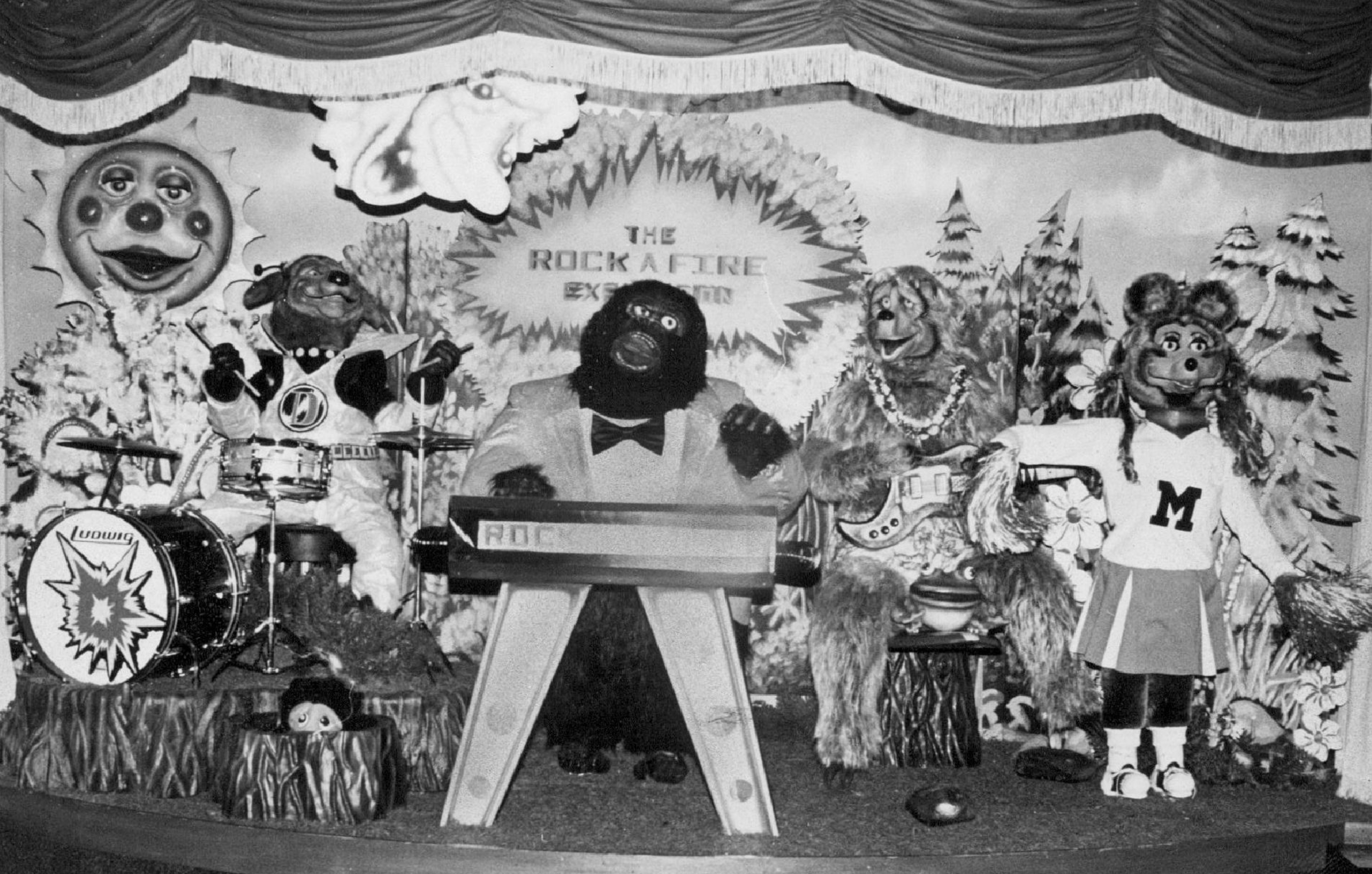 Animatronic band performing on stage with various animal characters playing instruments