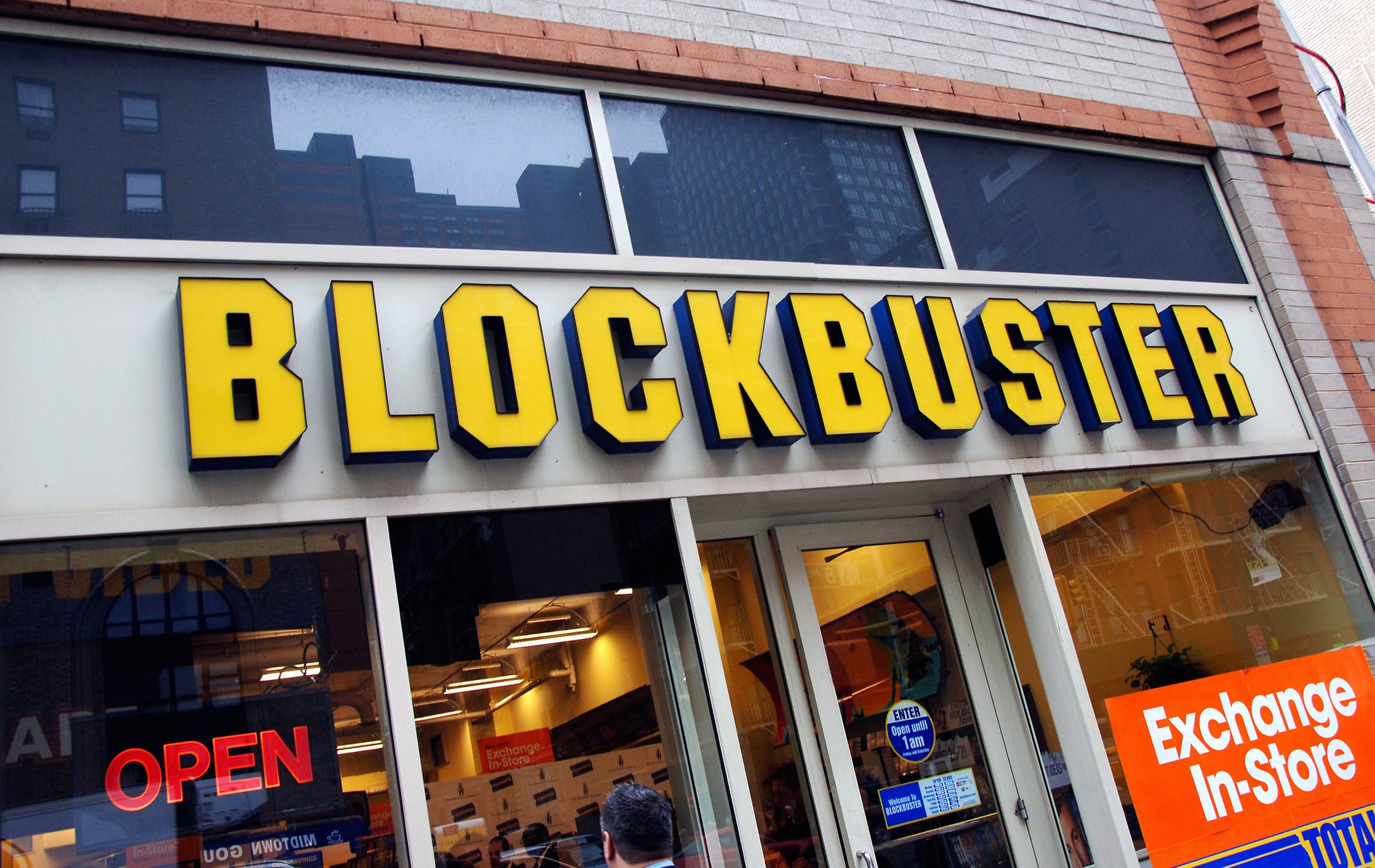 Blockbuster storefront with a large sign above the entrance. An "Open" sign is visible in the window