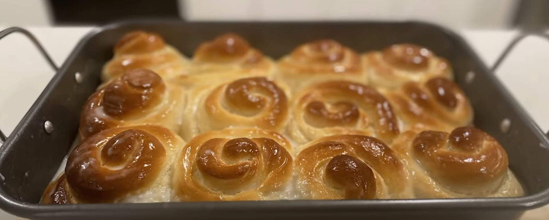Freshly baked cinnamon rolls in a rectangular baking tray