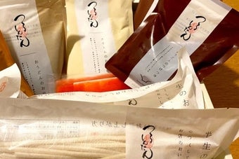 さまざまな種類のつけうどんやスープが箱に詰められている。