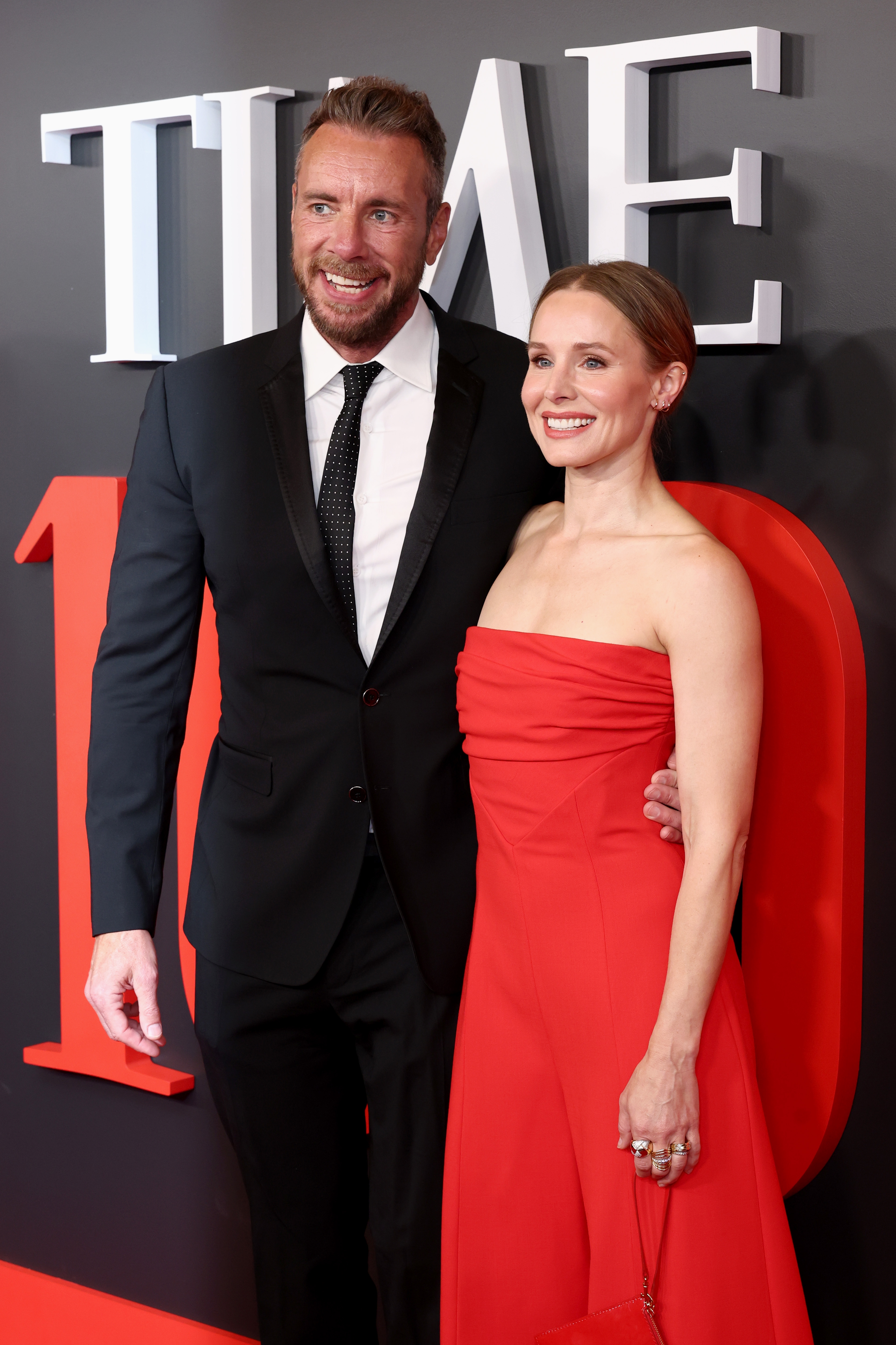Dax Shepard and Kristen Bell on a red carpet at a "Time 100" event