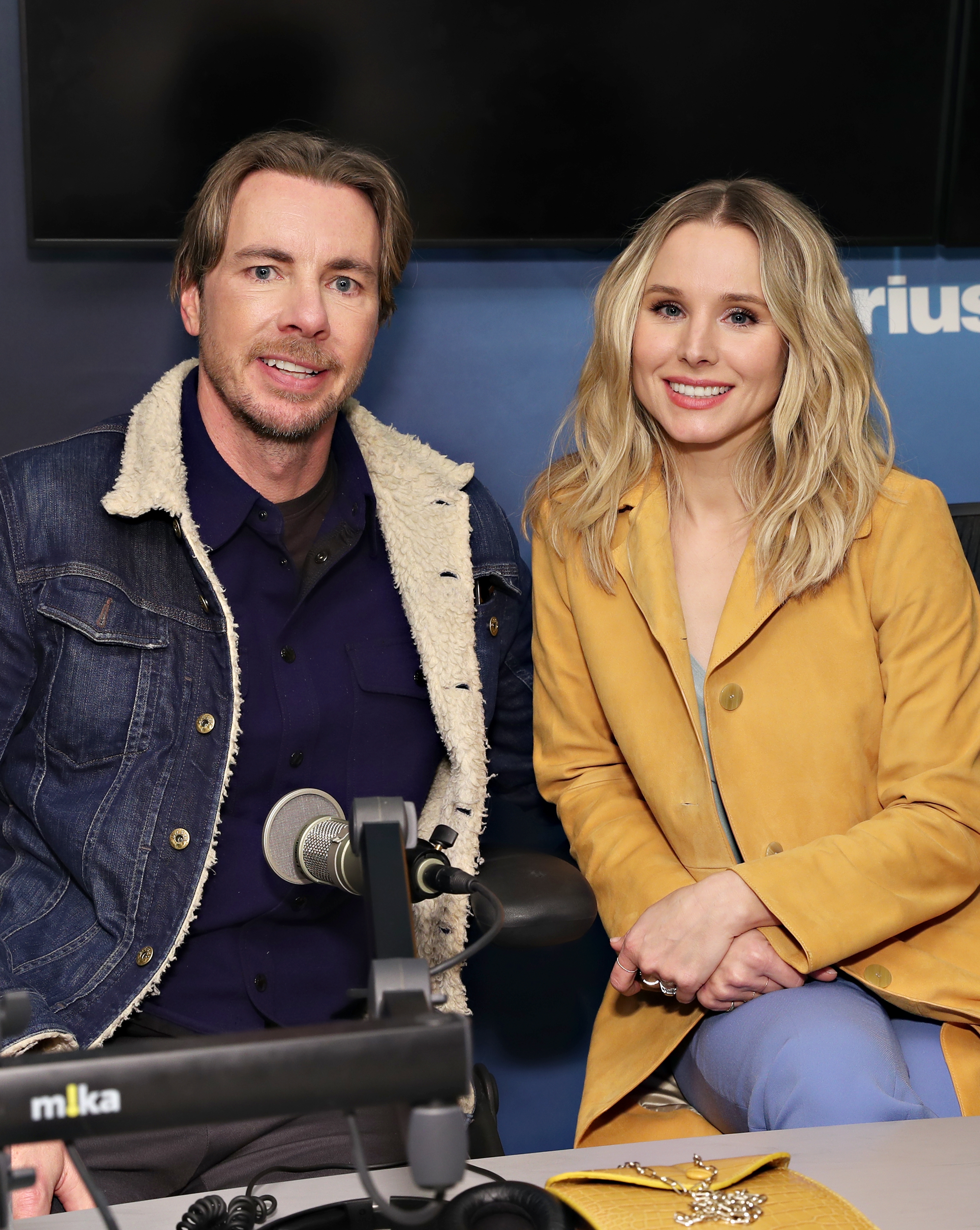Dax Shepard and Kristen Bell sitting together in a radio studio
