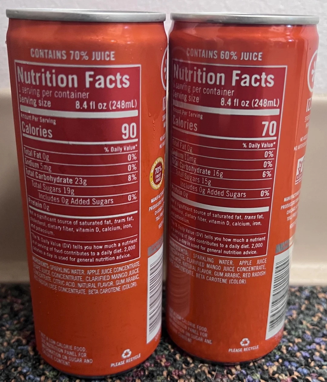 Two beverage cans with nutrition labels showing differences in juice content, calories, and sugars. One contains 70% juice, the other 60%