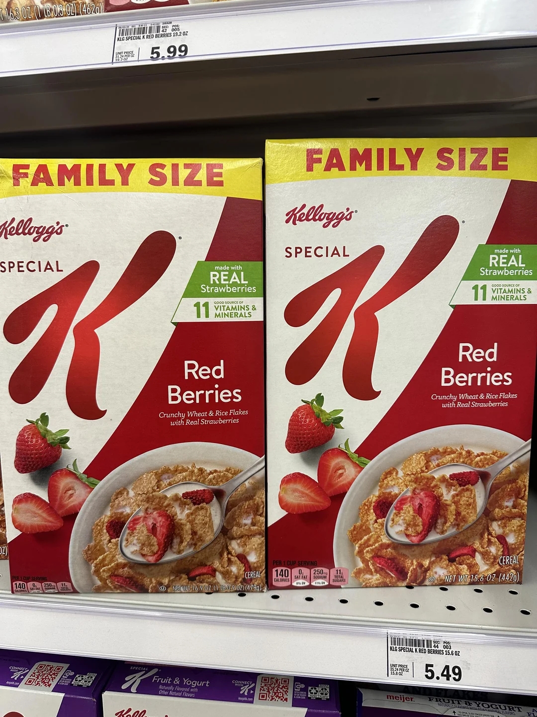 Two family-size boxes of Special K Red Berries cereal on a supermarket shelf, highlighting real strawberries and 11 vitamins and minerals. one box is taller than the other