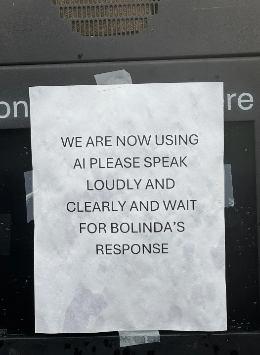 Sign in drive-thru requesting users to speak loudly and clearly when interacting with AI named Bolinda
