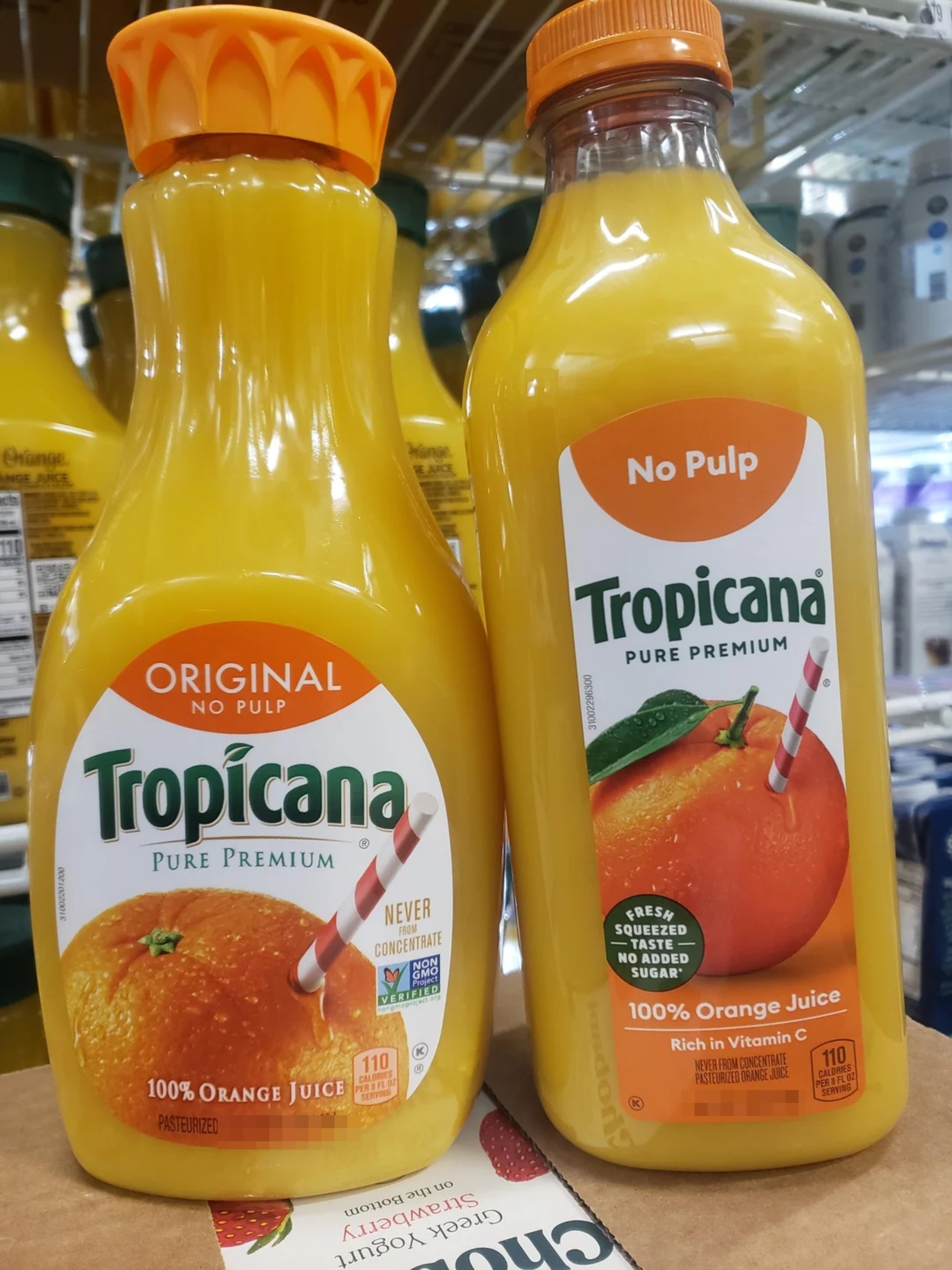 Tropicana orange juice bottles on a store shelf, labeled "Original" with "No Pulp" and "100% Orange Juice" prominently displayed