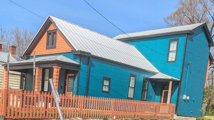 1 orangish and the different blue. A reddish picket obstruction surrounds the property