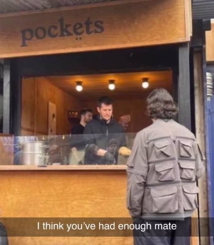 Person at a food stall named "pockets," facing a server. Caption humorously says, "I think you’ve had enough mate."